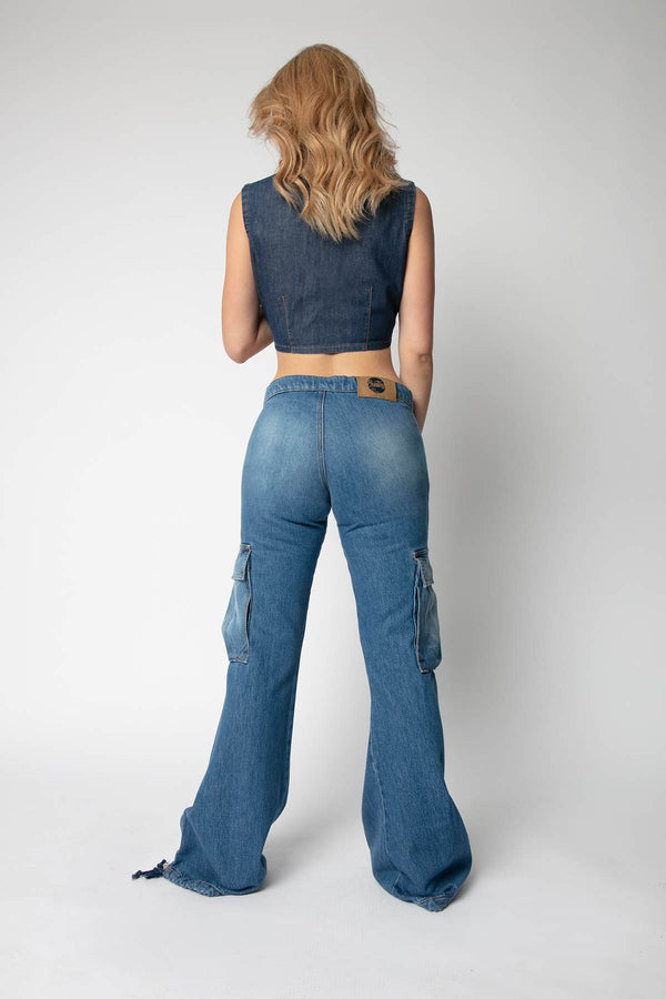 Woman wearing denim top and cargo jeans with back view