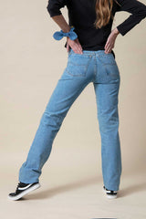 Rear detail of light blue jeans for women
